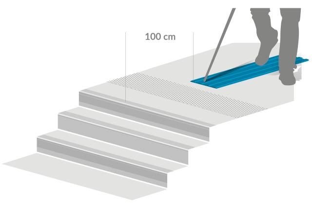 Illustration d'une bande de guidage pour malvoyants arrivant en haut d'un escalier